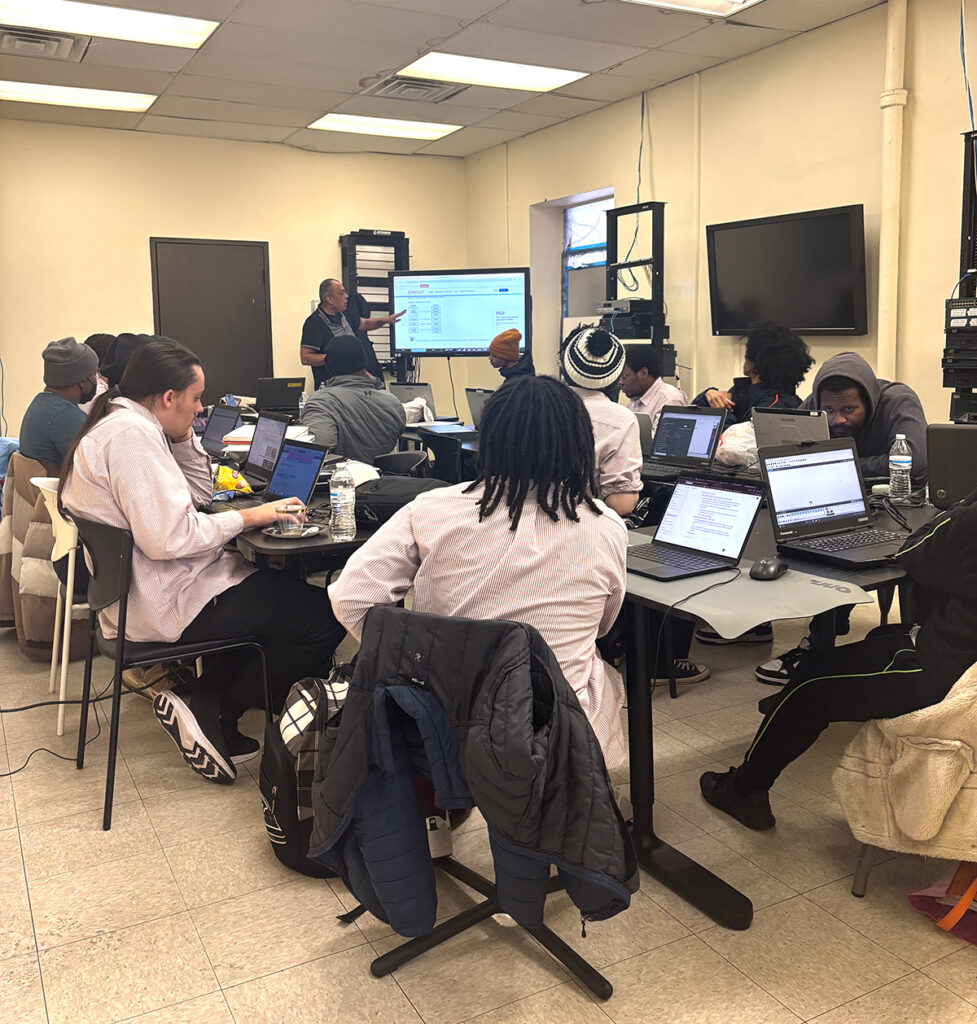 students in classroom on laptops learning technology